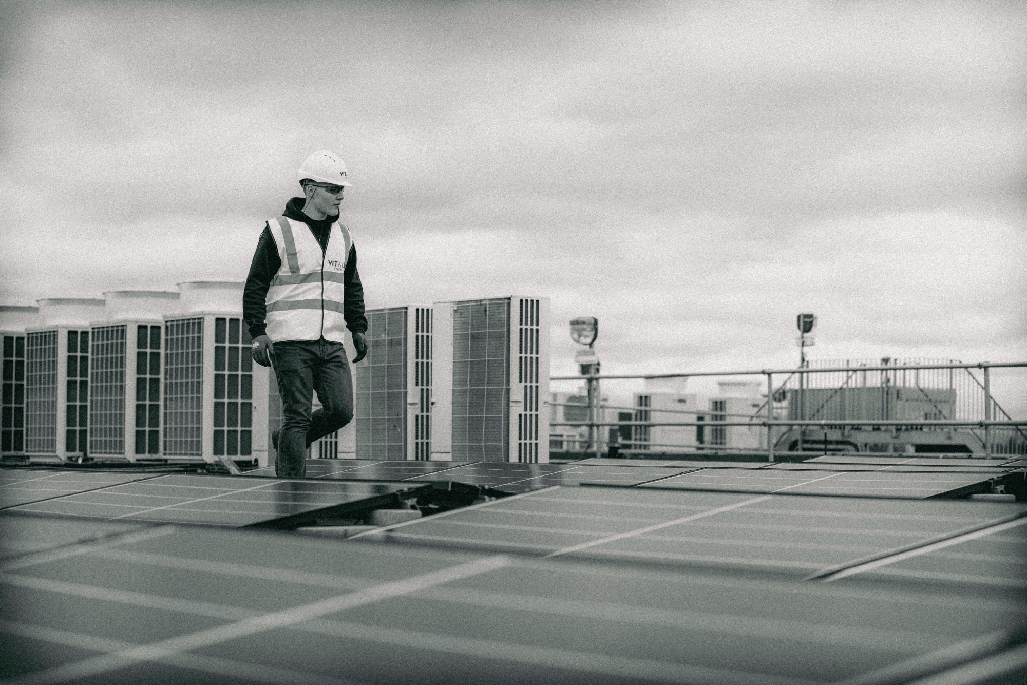 An HVAC technician inspecting rooftop units